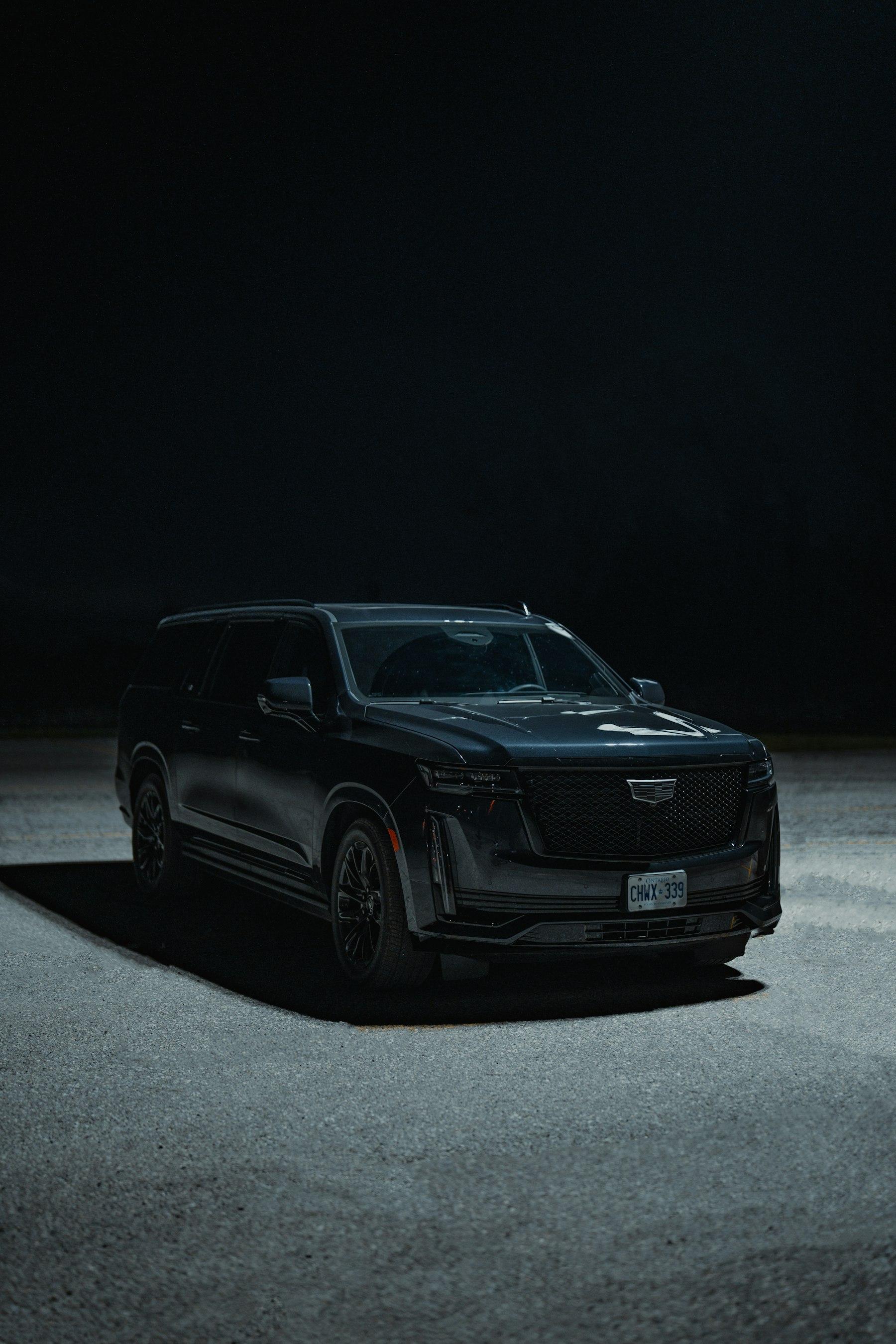 Full-size black SUV in the dark